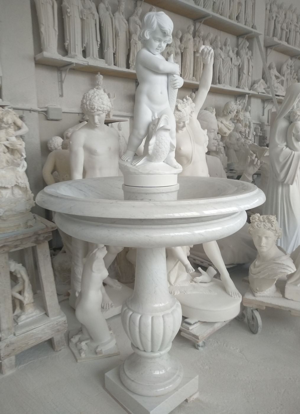 Marble fountain with sculpted cherub figures, Studio Giannoni Pietrasanta