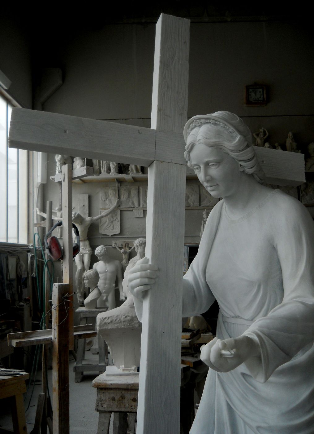 Marble crucifix with hand-carved figure, Studio Giannoni Pietrasanta workshop